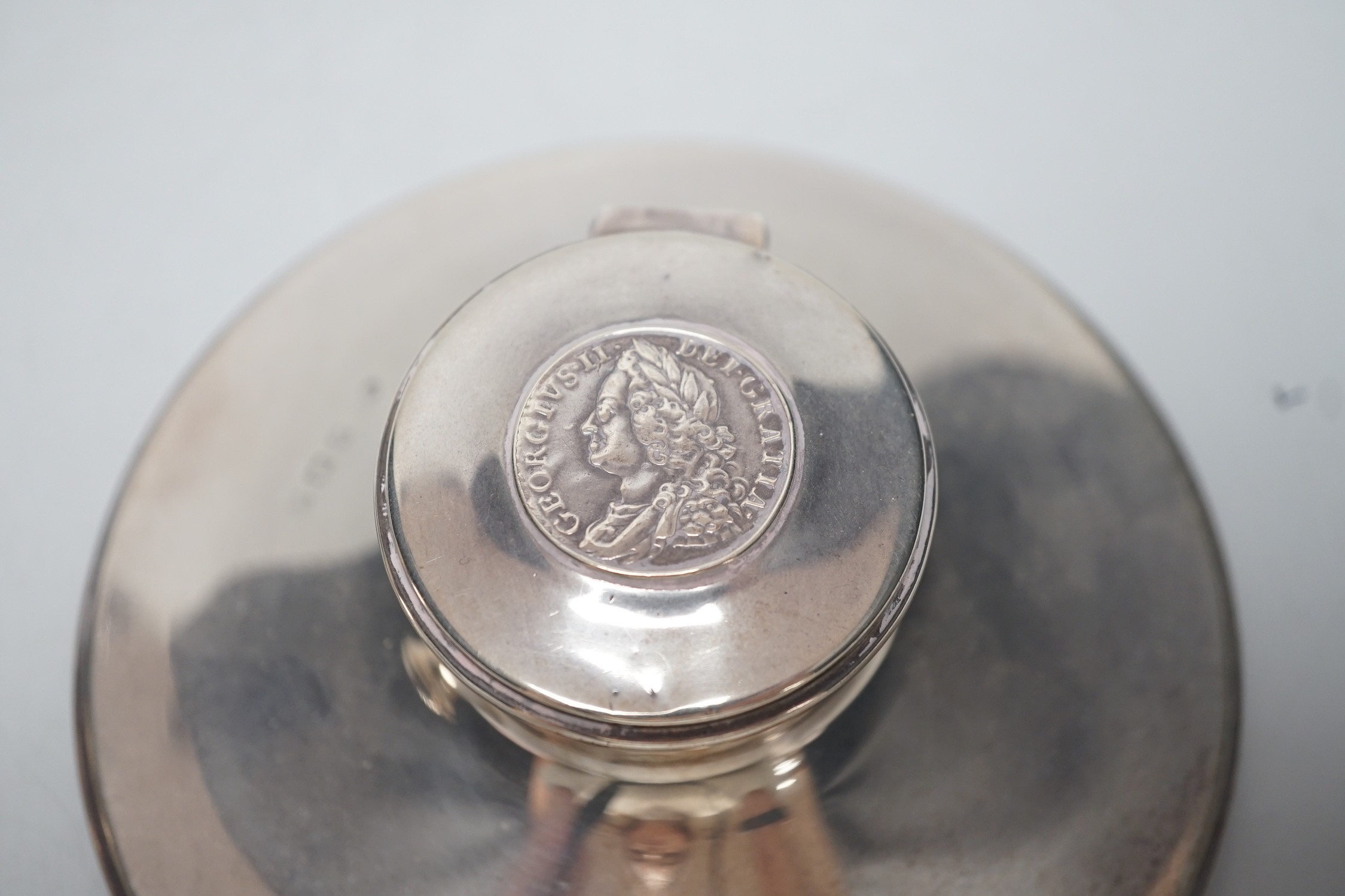 A George V silver mounted capstan inkwell, by Mappin & Webb, London, 1916, diameter 13.6cm and one other silver mounted capstan inkwell.